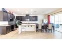 Modern kitchen featuring sleek black cabinets, stainless steel appliances, and a center island at 3556 Cheswick Dr, Ocoee, FL 34761