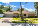 Inviting single-story home with a two-car garage, brick accents, and well-maintained landscaping at 400 Woodview Dr, Longwood, FL 32779