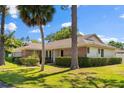 Charming single-story home with brick accents, a well-manicured lawn and mature trees adding to its curb appeal at 400 Woodview Dr, Longwood, FL 32779