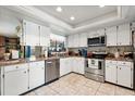 Well-lit kitchen featuring stainless steel appliances, white cabinets, and neutral countertops at 400 Woodview Dr, Longwood, FL 32779
