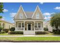 Charming two-story home with a inviting front porch and manicured lawn at 4094 Oak St, Orlando, FL 32814