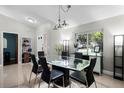 Bright dining room features a modern glass table, black chairs, and ample natural light from a large window at 485 Sandpiper Ridge Dr, Orlando, FL 32835