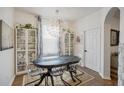 Well-lit dining room featuring modern lighting, a large window, and ample seating at 506 Pineloch Dr, Haines City, FL 33844