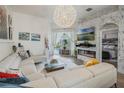 Bright living room with fireplace, large sectional, and access to the outdoor pool area at 506 Pineloch Dr, Haines City, FL 33844