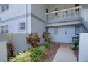 Close up of walkway leading to the entrance with white railing, and tropical landscaping at 576 Fairways Ln # M103, Ocala, FL 34472