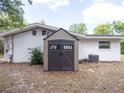 Backyard with an outdoor shed and AC unit next to the house at 633 Hermits Trail, Altamonte Springs, FL 32701