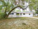 Single-story home featuring a well-maintained lawn and mature trees at 633 Hermits Trail, Altamonte Springs, FL 32701