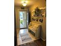 Welcoming entryway with tile flooring, a decorative bench, and 