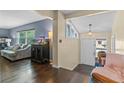Bright living room with hardwood floors, large windows, and a decorative aquarium, great for entertaining at 1010 Chokecherry Dr, Winter Springs, FL 32708