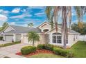 Inviting single story home showcasing beautiful landscaping, brick pavers, and a well-maintained lawn at 10621 Golden Cypress Ct, Orlando, FL 32836