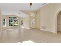 Bright living room with tiled floors and large windows providing ample natural light throughout the house at 10621 Golden Cypress Ct, Orlando, FL 32836