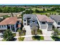 An aerial of the home showing a stone driveway, mature landscaping, and community at 1080 E Jack Nicklaus Ct, Kissimmee, FL 34747