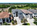 An aerial view of luxury home exteriors with stunning architecture, landscaping, and well-manicured lawns at 1080 E Jack Nicklaus Ct, Kissimmee, FL 34747