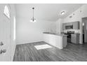 Modern kitchen features granite countertops, stainless steel appliances, and an open layout with a view of the dining area at 12388 Se 106Th Ave, Belleview, FL 34420