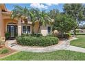 Lovely home entrance featuring well-kept landscaping and a welcoming walkway at 128 Lake Region Cir, Winter Haven, FL 33881