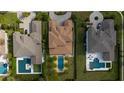 Aerial view of a luxury home with a pool, palm trees, manicured lawns, and a paver driveway at 13125 Casabella Dr, Windermere, FL 34786