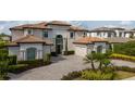 Attractive two-story home with well-maintained landscaping, a circular driveway, and an attached two-car garage at 13125 Casabella Dr, Windermere, FL 34786