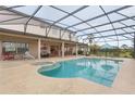 Inviting screened-in pool area with ample seating and a relaxing spa, perfect for outdoor entertaining at 13640 Dornoch Dr, Orlando, FL 32828
