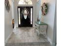 Lovely foyer featuring decorative artwork and beautiful floors at 1474 Thornhill Cir, Oviedo, FL 32765