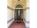 The front door features decorative glass and a transom window at 1474 Thornhill Cir, Oviedo, FL 32765
