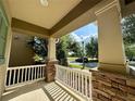 Inviting front porch with stone accents and white railing, perfect for relaxing outdoors at 15157 Pigeon Plum Ln, Winter Garden, FL 34787