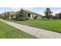 Well-maintained home showcasing lush green grass and an elegant fence, creating a serene outdoor space at 16892 Hypatia Aly, Winter Garden, FL 34787