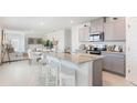 Spacious kitchen with island seating that opens to the dining and living areas at 186 Amberwood Way, Umatilla, FL 32784