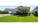 Lovely home showcasing a pristine lawn and lush landscaping, enhancing its curb appeal at 1925 Estuary Ln, Kissimmee, FL 34747
