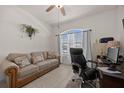 Inviting office with a comfortable sofa, desk, and plenty of natural light, creating a productive workspace at 2380 Kaley Ridge Rd, Clermont, FL 34715