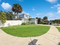 Inviting two-story home featuring a lush green lawn and a white picket fence at 2601 Spring Hill Dr, Kissimmee, FL 34743