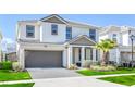 A modern two-story home boasting a gray roof, neutral colored stucco, and a gray two-car garage at 2618 Calistoga Ave, Kissimmee, FL 34741