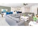 A bright and airy living room and dining room are with comfortable gray sofas and modern decor at 2618 Calistoga Ave, Kissimmee, FL 34741