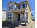 Construction of a two-story home with a covered porch and multiple windows at 2963 Embark Trail, St Cloud, FL 34771