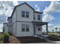 Well-designed two-story home featuring a cozy front porch and multiple windows at 2963 Embark Trail, St Cloud, FL 34771