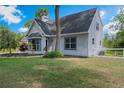 Beautifully landscaped single-Gathering home featuring a lush lawn, mature trees, and well-maintained exterior at 30746 Fairview Ave, Tavares, FL 32778