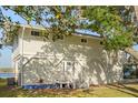Charming home exterior with mature trees, porch, and well-maintained landscaping at 3216 John Anderson Dr, Ormond Beach, FL 32176