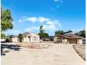 Lovely single-story home boasts a circular driveway and well-maintained landscaping under a clear blue sky at 4705 Beggs Rd, Orlando, FL 32810