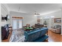 Bright living room with hardwood floors, ceiling fan, comfortable seating, and natural light at 4705 Beggs Rd, Orlando, FL 32810