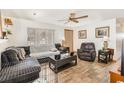 Cozy living room featuring tile floors, a ceiling fan, and abundant natural light at 4723 Cherokee Rose Dr, Orlando, FL 32808