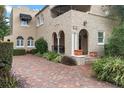 Beautiful home featuring an arched entrance, brick driveway, and well-maintained landscaping at 511 Woodlawn Blvd, Orlando, FL 32801