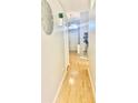 Bright hallway featuring wood flooring, neutral walls, and decorative wall decor at 526 Seasons Ct, Winter Springs, FL 32708