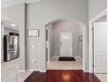 Open foyer with archway, light gray walls, and stylish tile flooring, creating a welcoming entry at 5707 Fischer Dr, Lakeland, FL 33812