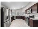 Spacious kitchen featuring stainless steel appliances, dark cabinetry, and granite countertops, a chef's dream at 5707 Fischer Dr, Lakeland, FL 33812