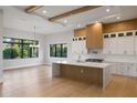 Contemporary kitchen featuring a center island, white cabinets and wood accents at 5762 Emerington Cres, Orlando, FL 32819