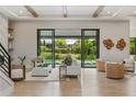 Open-concept living room featuring hardwood floors, comfortable seating, and sliding glass doors to the outdoor pool area at 5762 Emerington Cres, Orlando, FL 32819