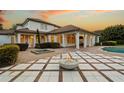 Spacious backyard features a covered patio, fire pit, and outdoor kitchen area, great for entertaining at 6143 Cartmel Ln, Windermere, FL 34786