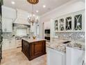 Gourmet kitchen with island, stainless appliances, and decorative backsplash at 6143 Cartmel Ln, Windermere, FL 34786
