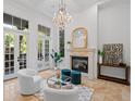 Bright living room boasts a fireplace, large windows, and plush seating, perfect for relaxation at 6143 Cartmel Ln, Windermere, FL 34786