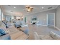 Bright and spacious living room area with tile floors, ceiling fan, recessed lights, and an open floor plan at 6667 Alder Rd, Harmony, FL 34773