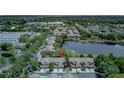 Aerial view of townhomes nestled near a picturesque lake, providing tranquil community setting at 8419 Chamberlain Pl, Oviedo, FL 32765